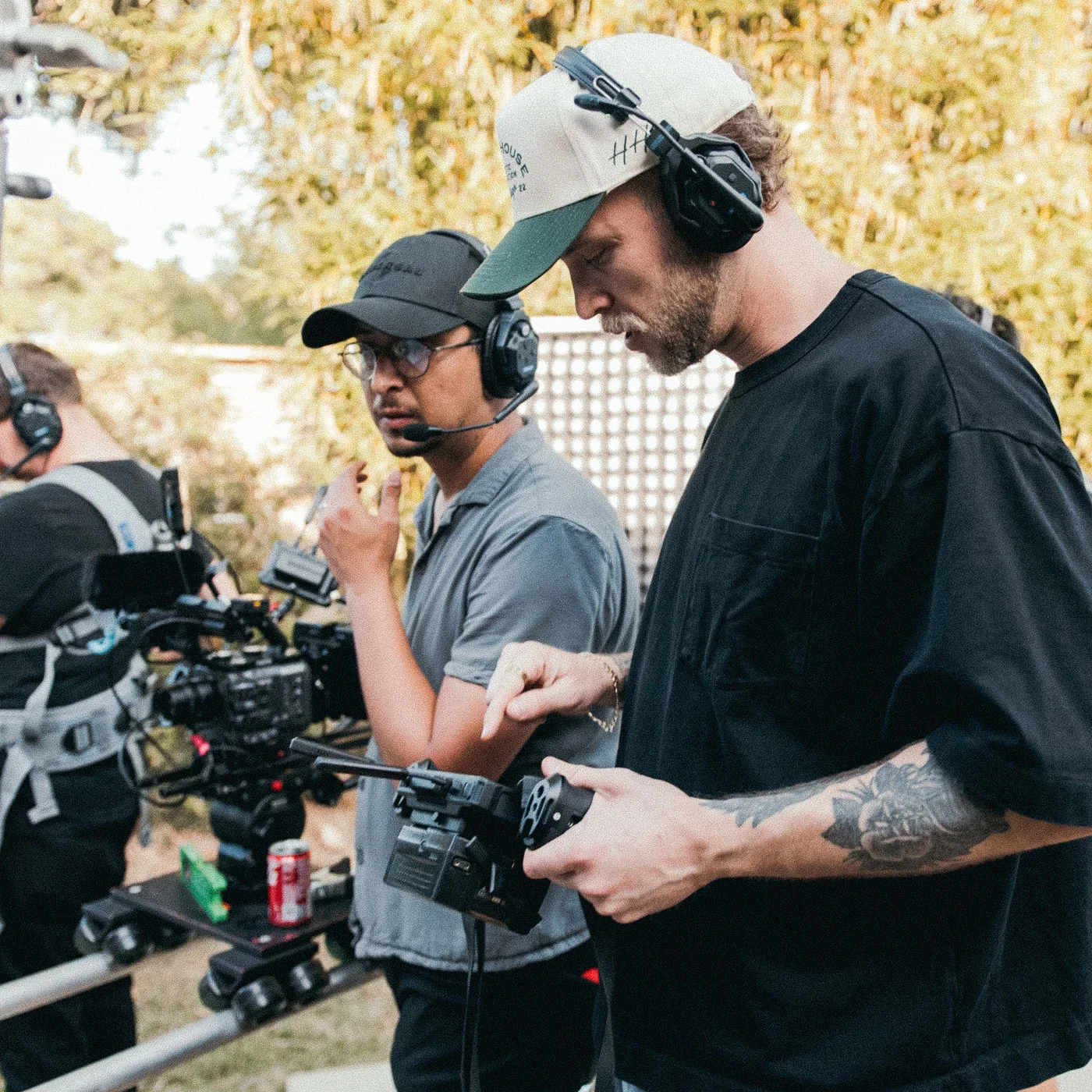 Film crew working together around a professional cinema camera during an outdoor production